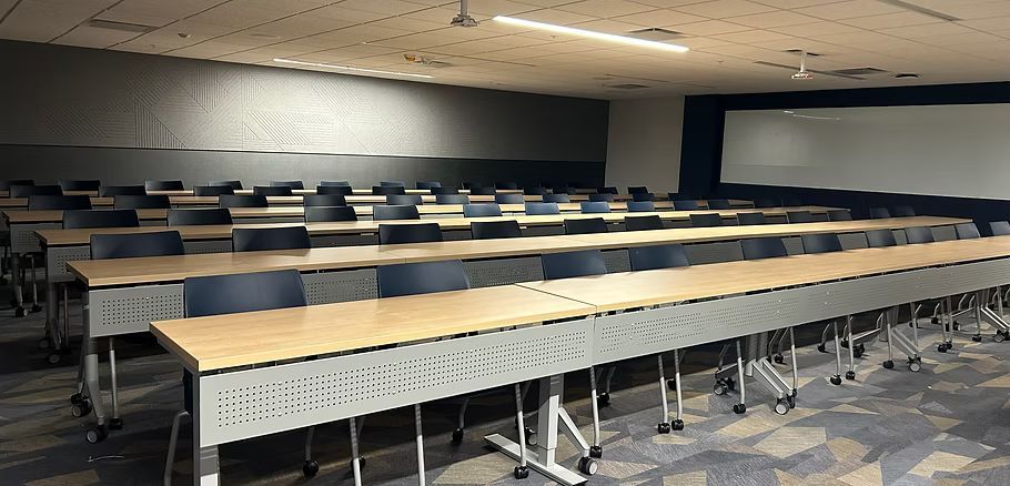 There are a lot of tables and chairs in this room.