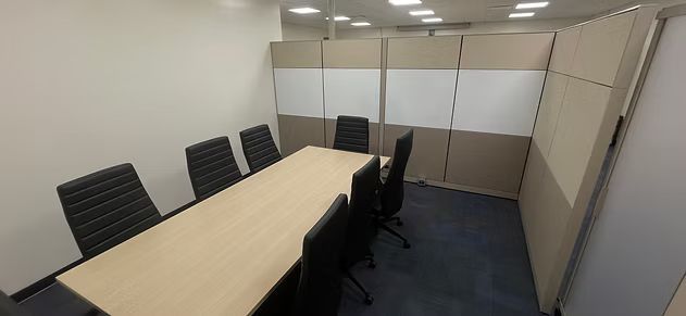 A conference room with a long table and chairs.