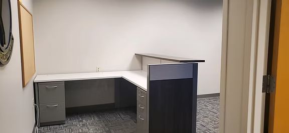 There is a desk in the middle of the room.