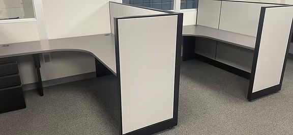 Two cubicles are sitting next to each other in an office.