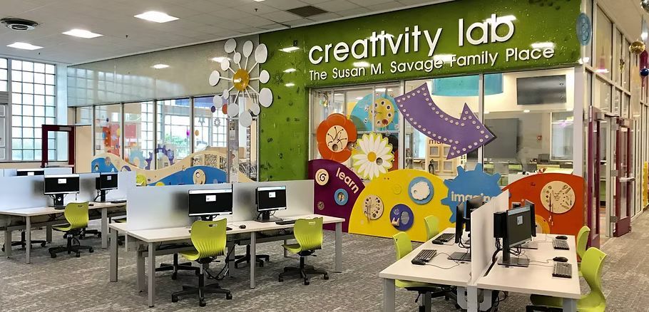 A creativity lab with tables and chairs and computers.