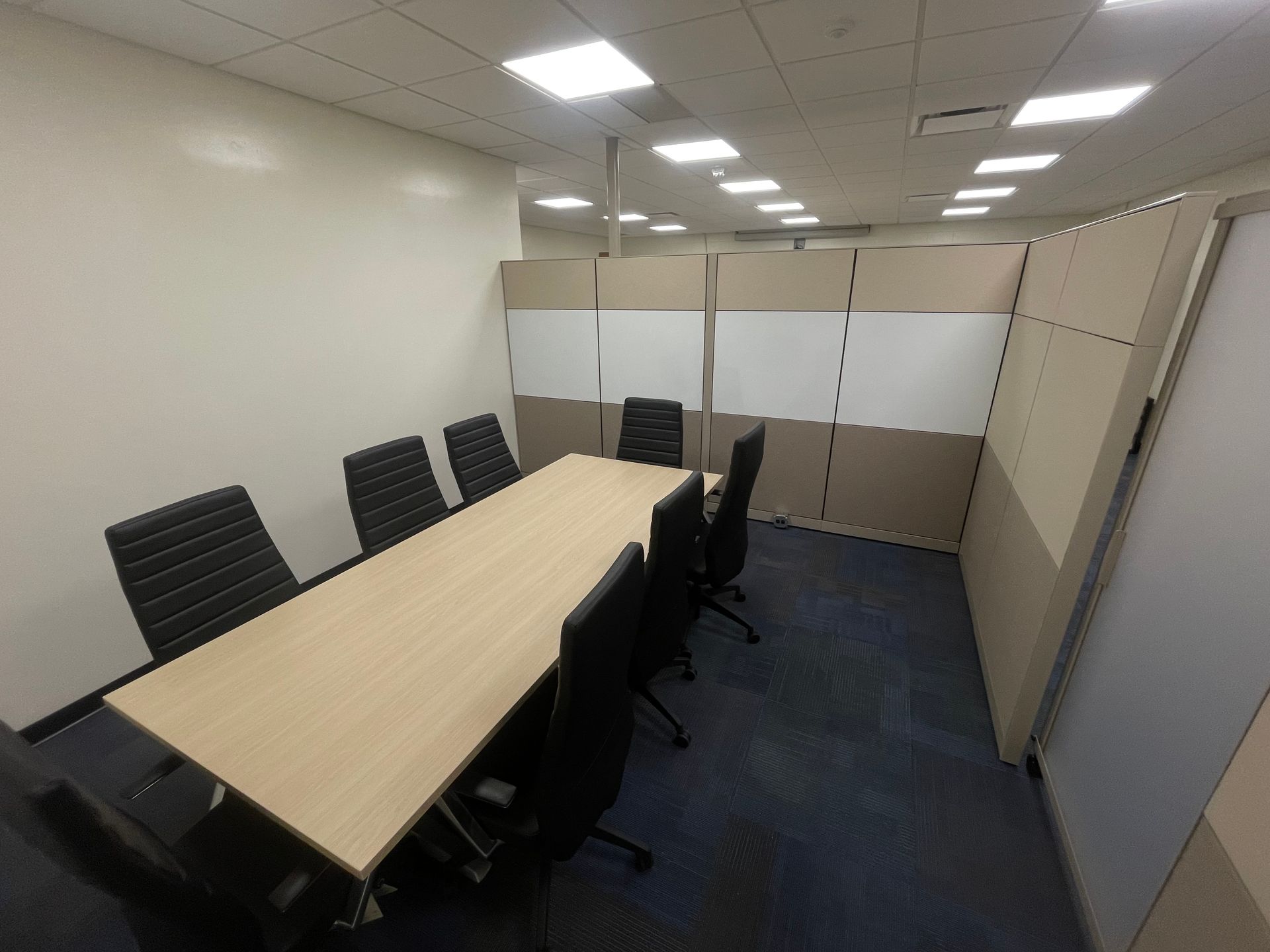 A conference room with a long table and chairs