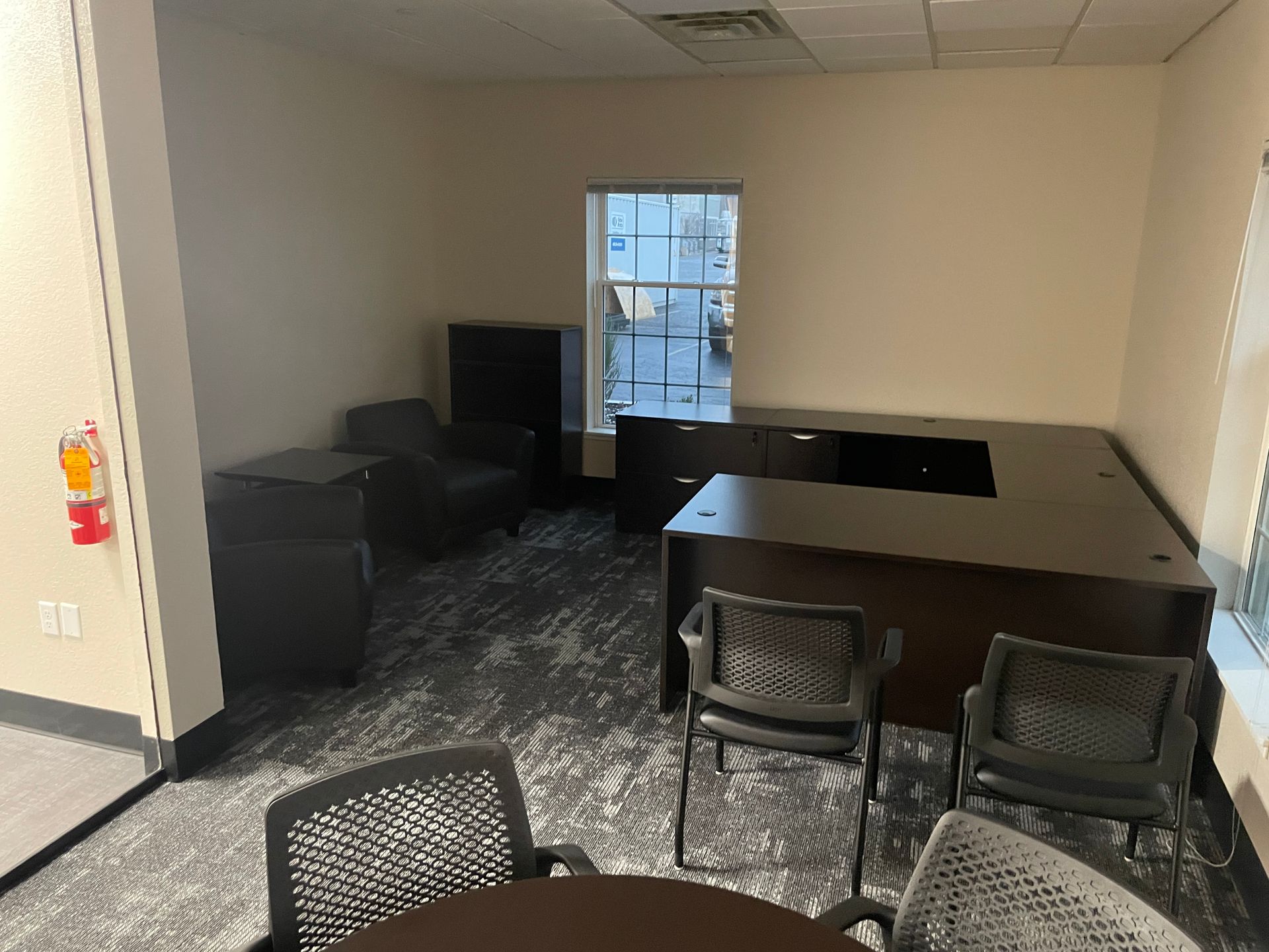 A room with a table , chairs , and a window.