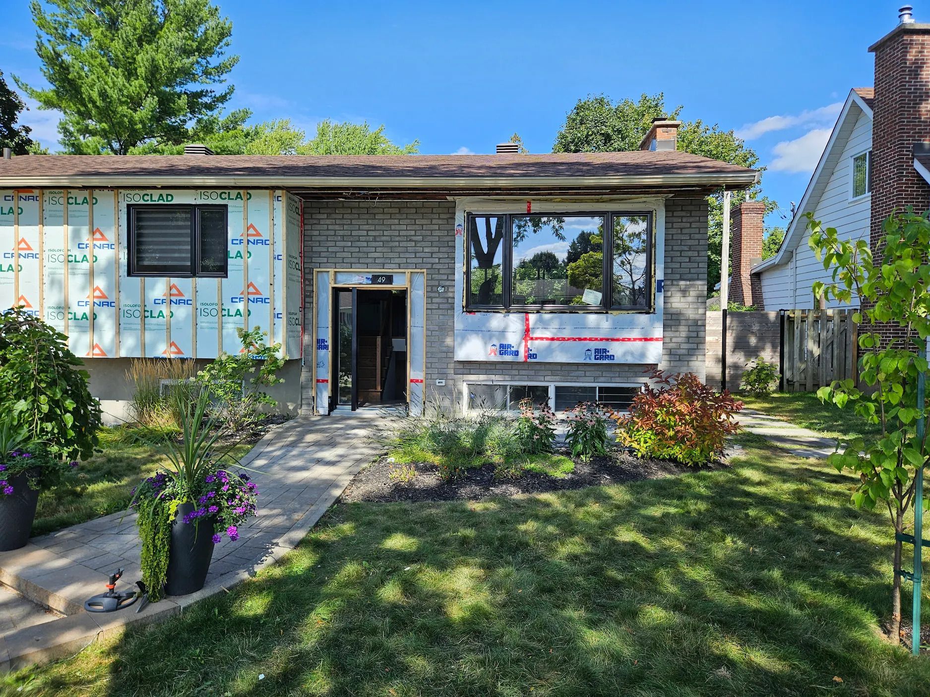 Une maison avec beaucoup de fenêtres est en cours de rénovation.