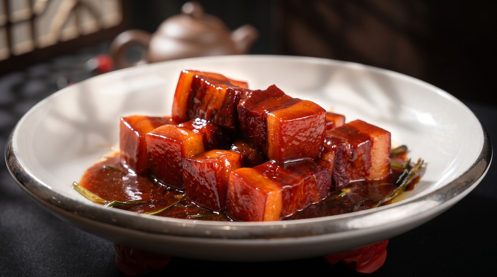Braised tofu cubes in glossy brown sauce on a white plate