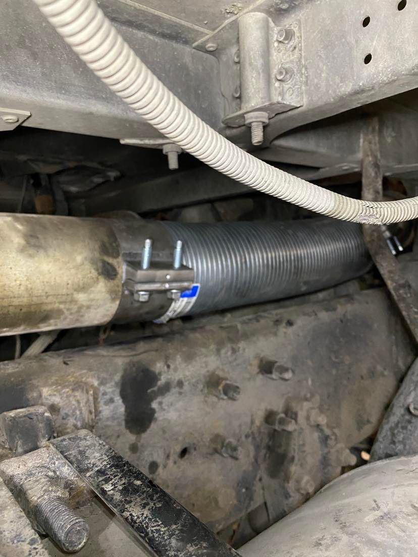 Un gros plan d'un tuyau fixé sous un véhicule.