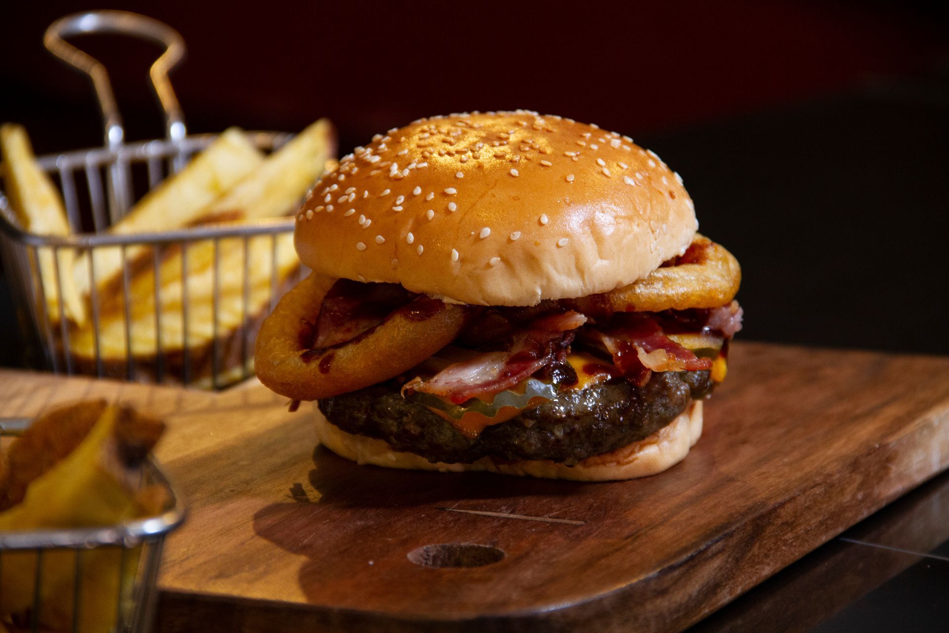 Hamburger with onion rings, melted cheese and meat. Hamburger with onion rings, melted cheese and meat.