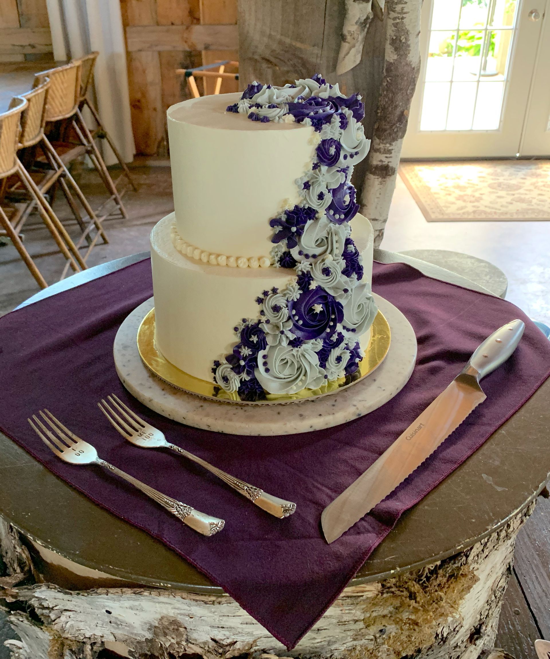 Mix It Up! custom wedding cakes 2 tier cake with white frosting with  purple and white flowers on it