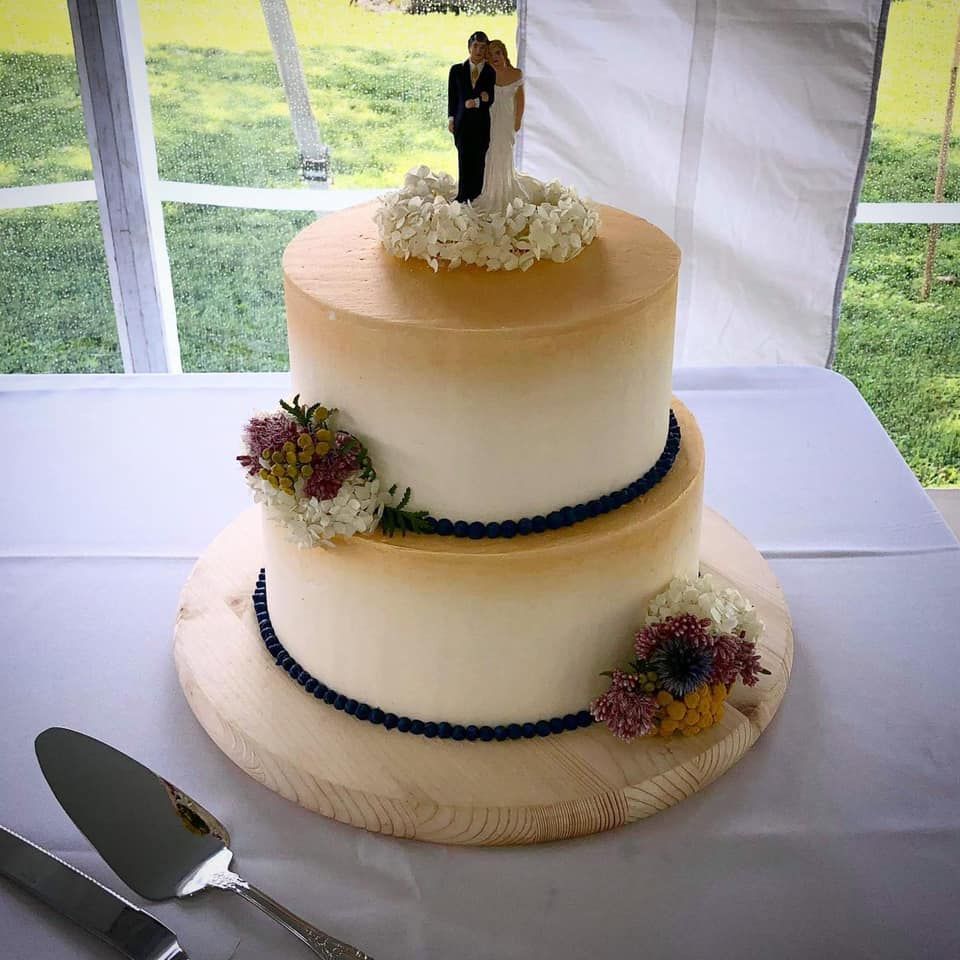 Mix It Up! custom wedding cakes 2 tier cake with white and light brown frosting with  brown and white flowers flowers on it