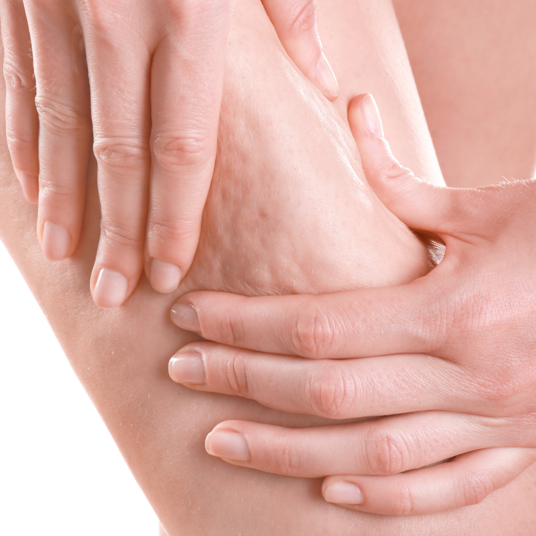 Hands holding and massaging a person’s lower back in a close-up shot