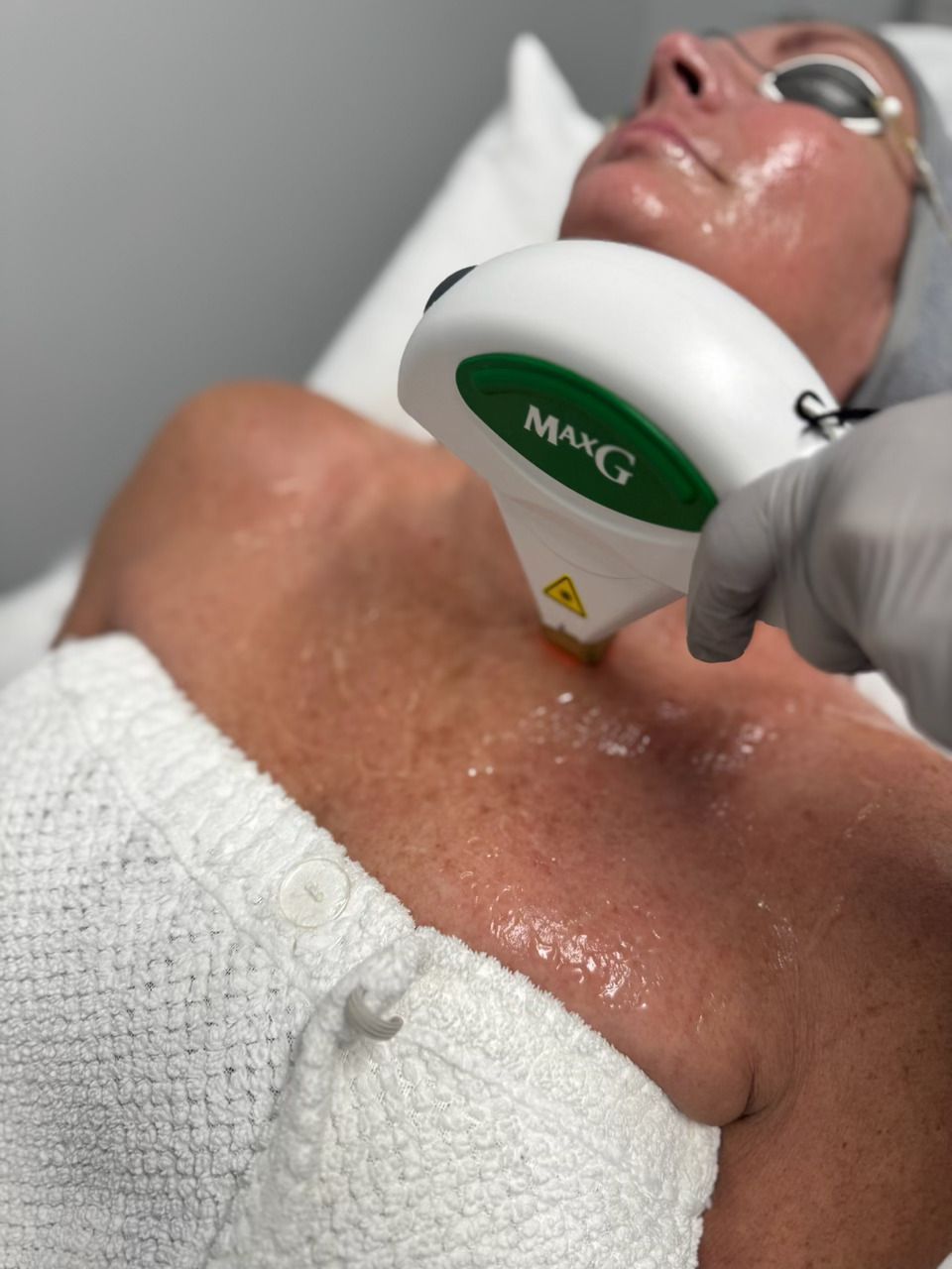 A woman is getting a photofacial treatment at a med spa.