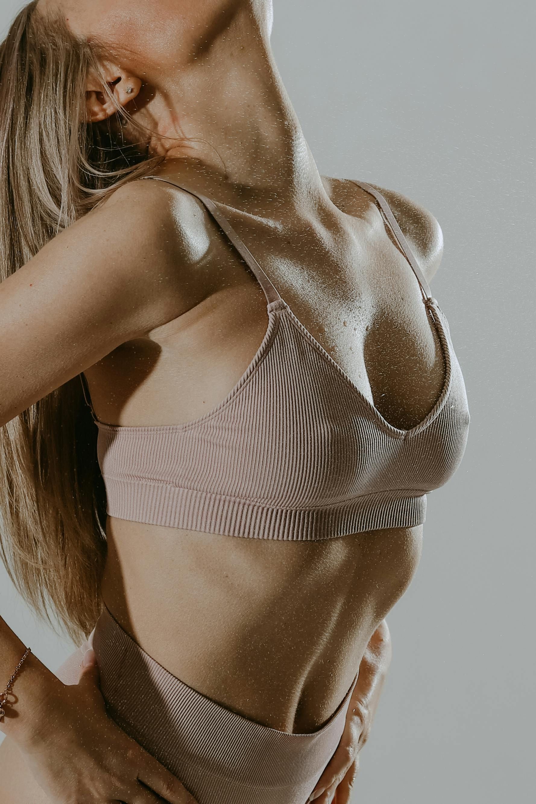 The woman is wearing a bikini top and high waisted bottoms.