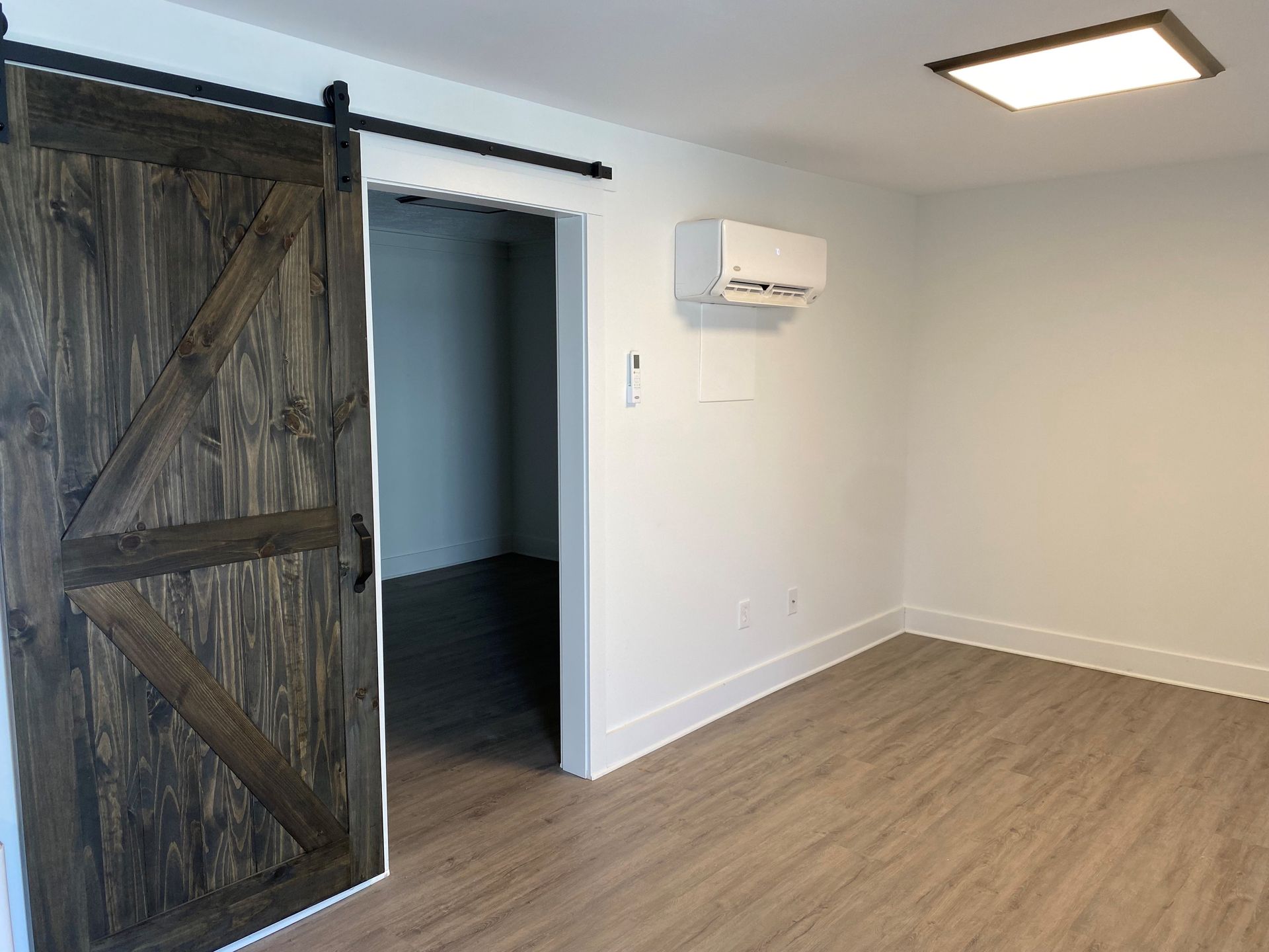 There is a sliding barn door in the middle of the room.