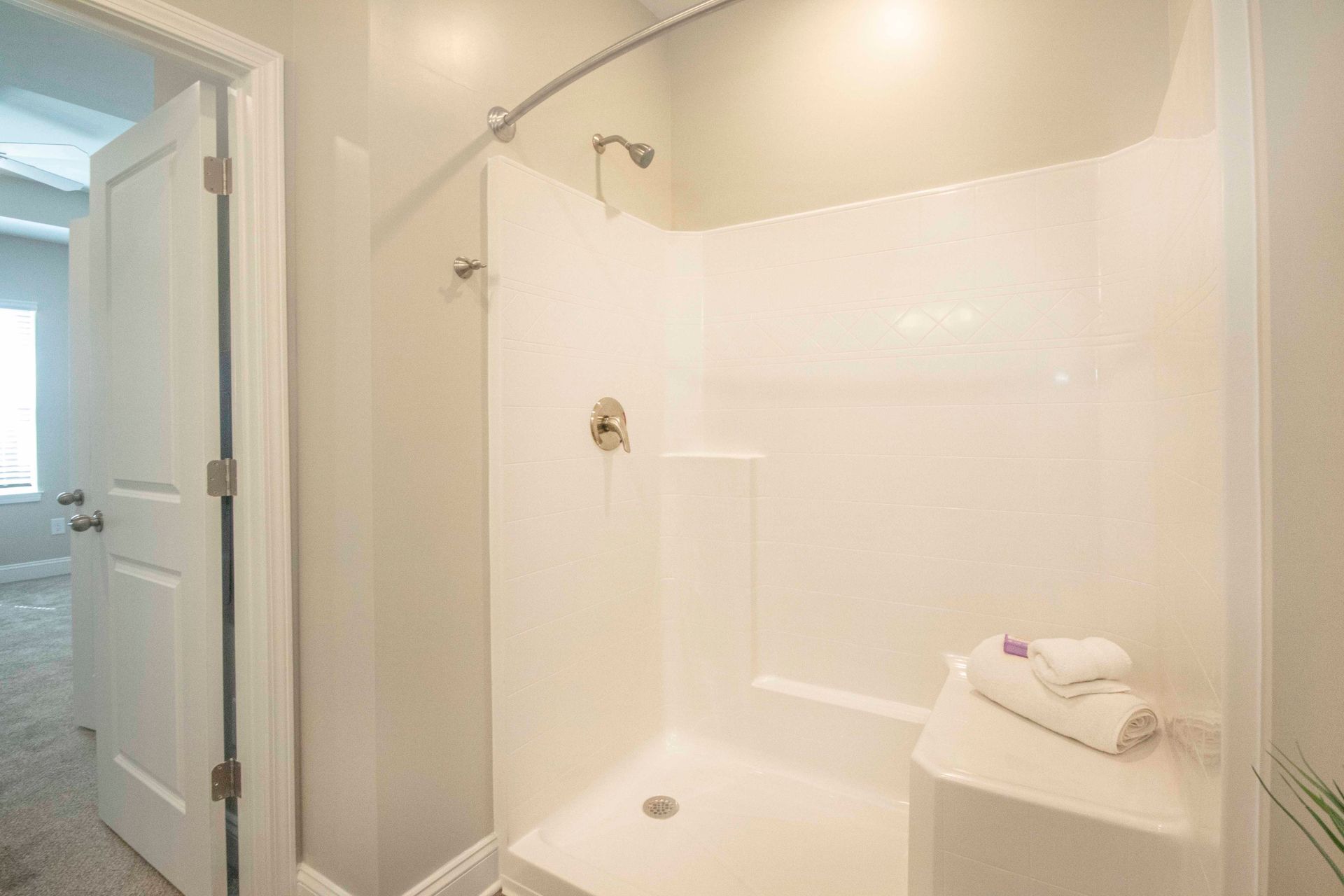 A bathroom with a walk in shower and a toilet.