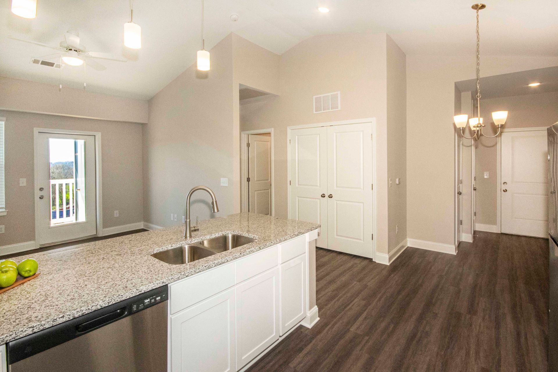 A kitchen with granite counter tops and stainless steel appliances.