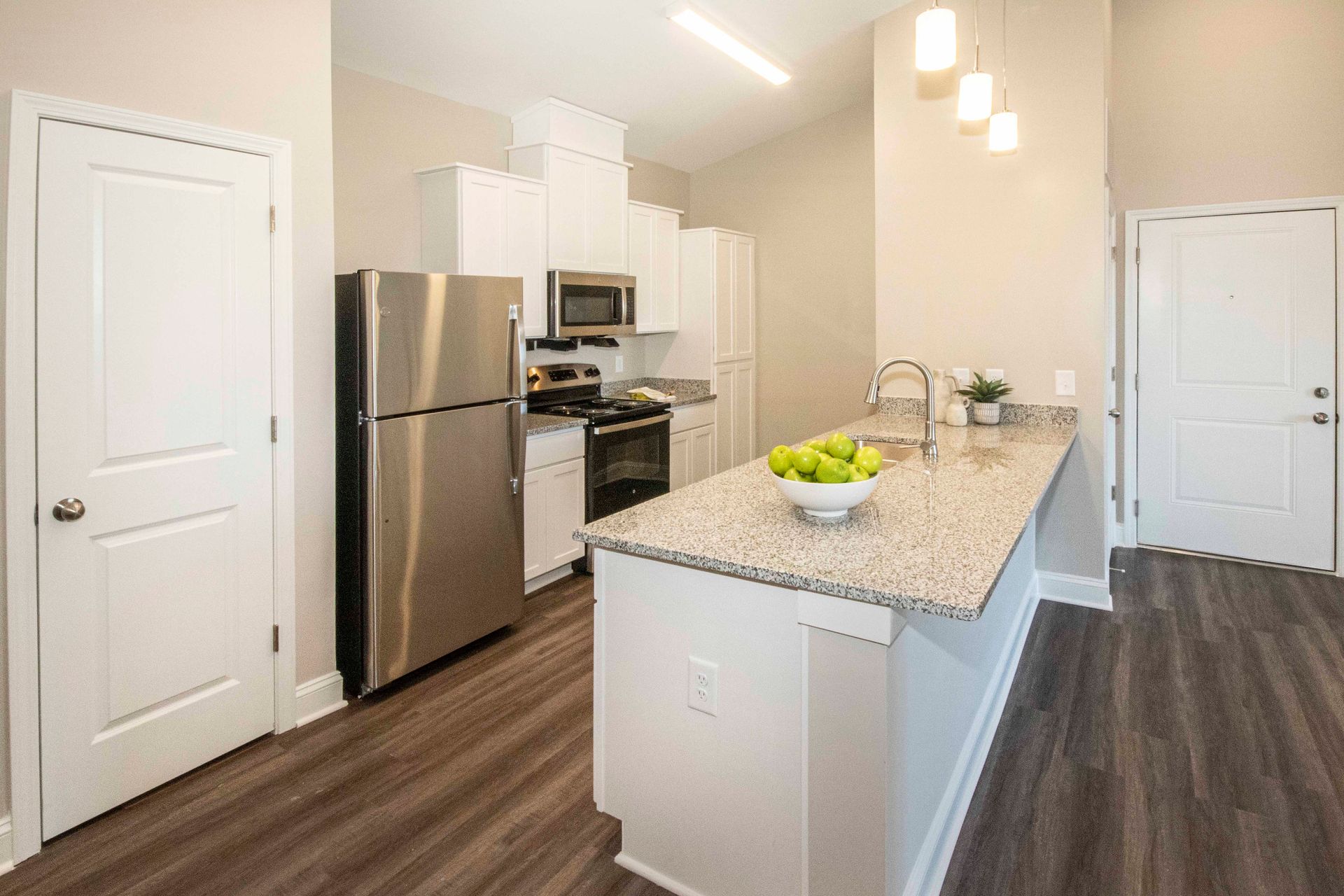 A kitchen with stainless steel appliances and granite counter tops.
