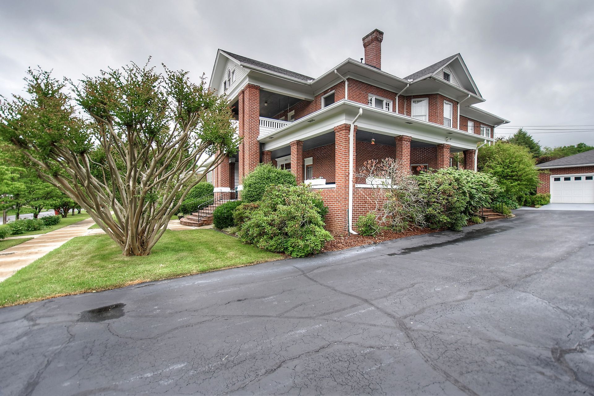 A large brick house with a porch and a garage