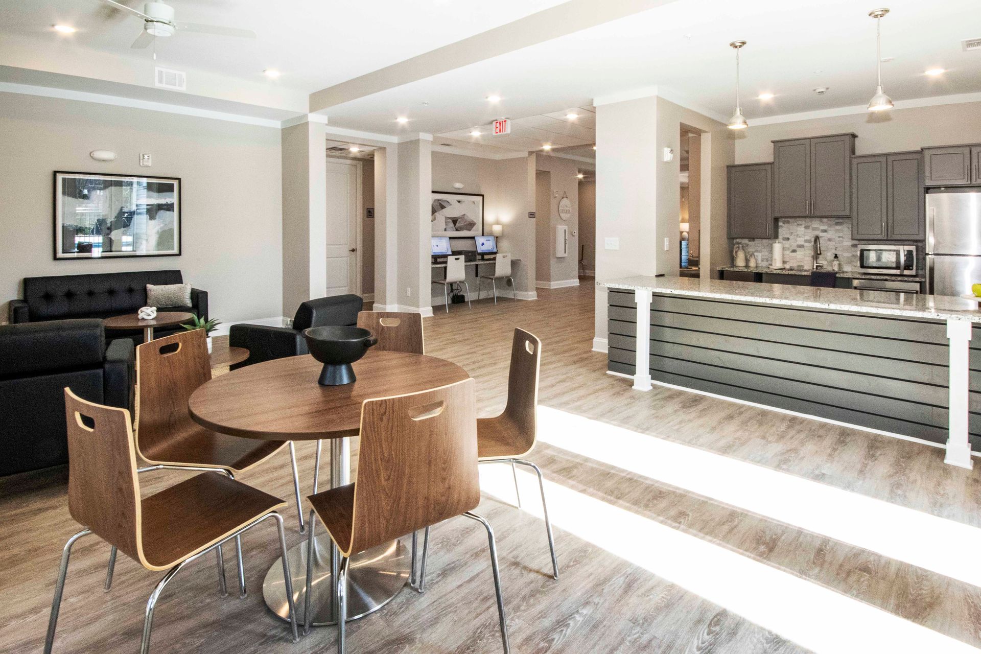 There is a table and chairs in the middle of the room.
