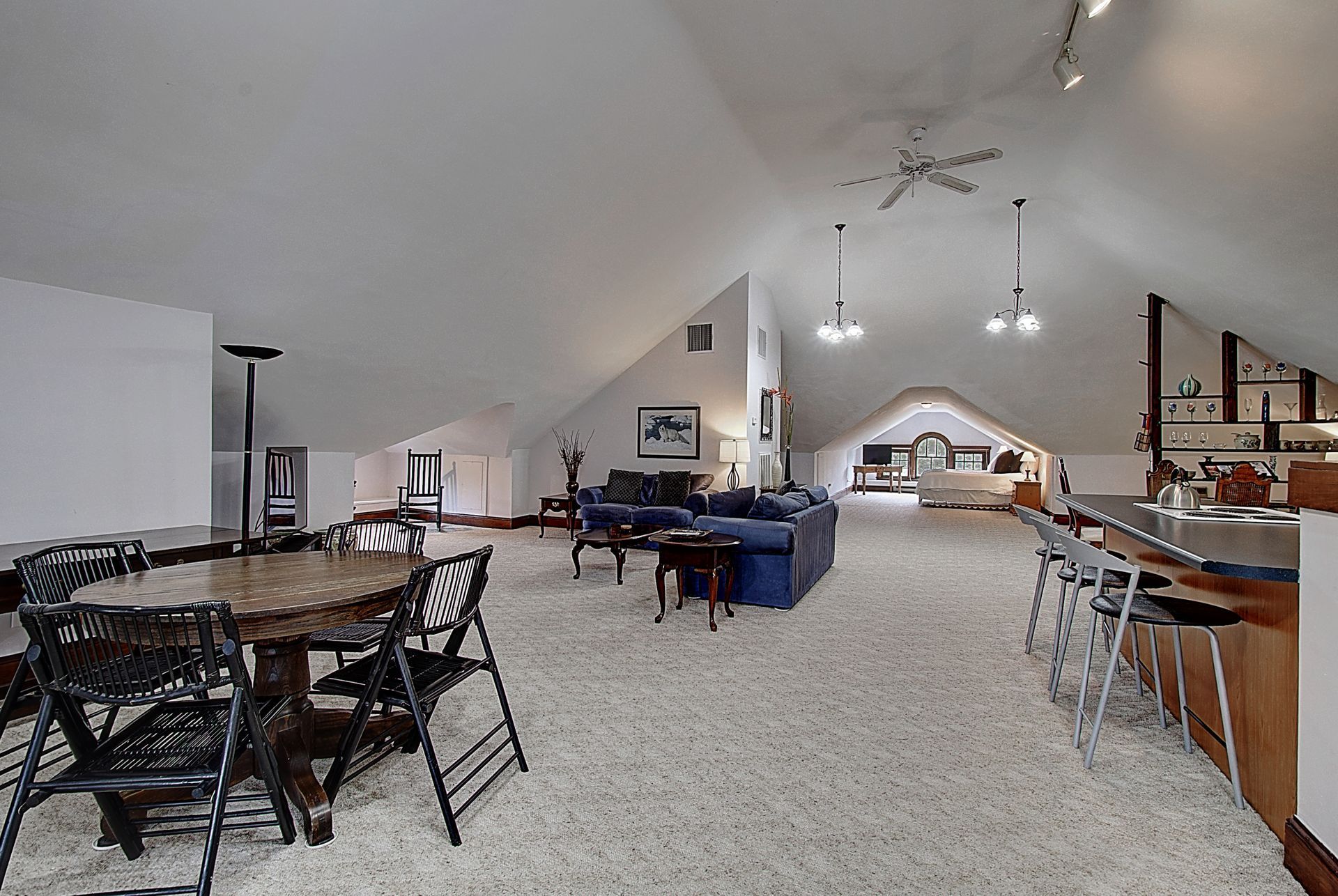A large room with a table and chairs in it