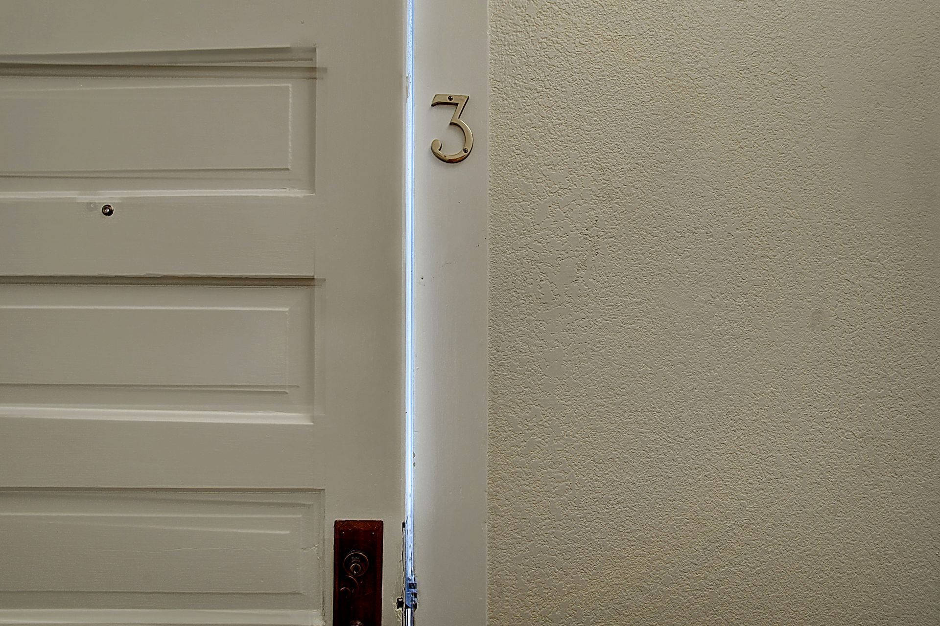 A white door with the number three on it