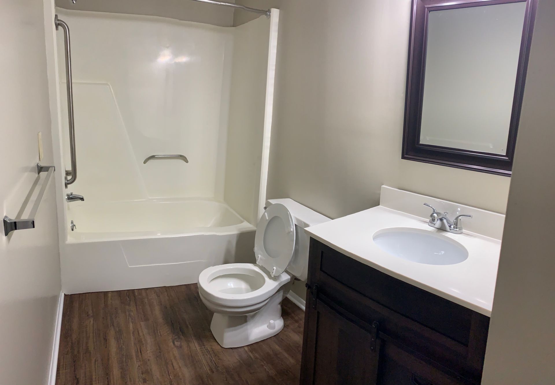 A bathroom with a toilet , sink , and bathtub.