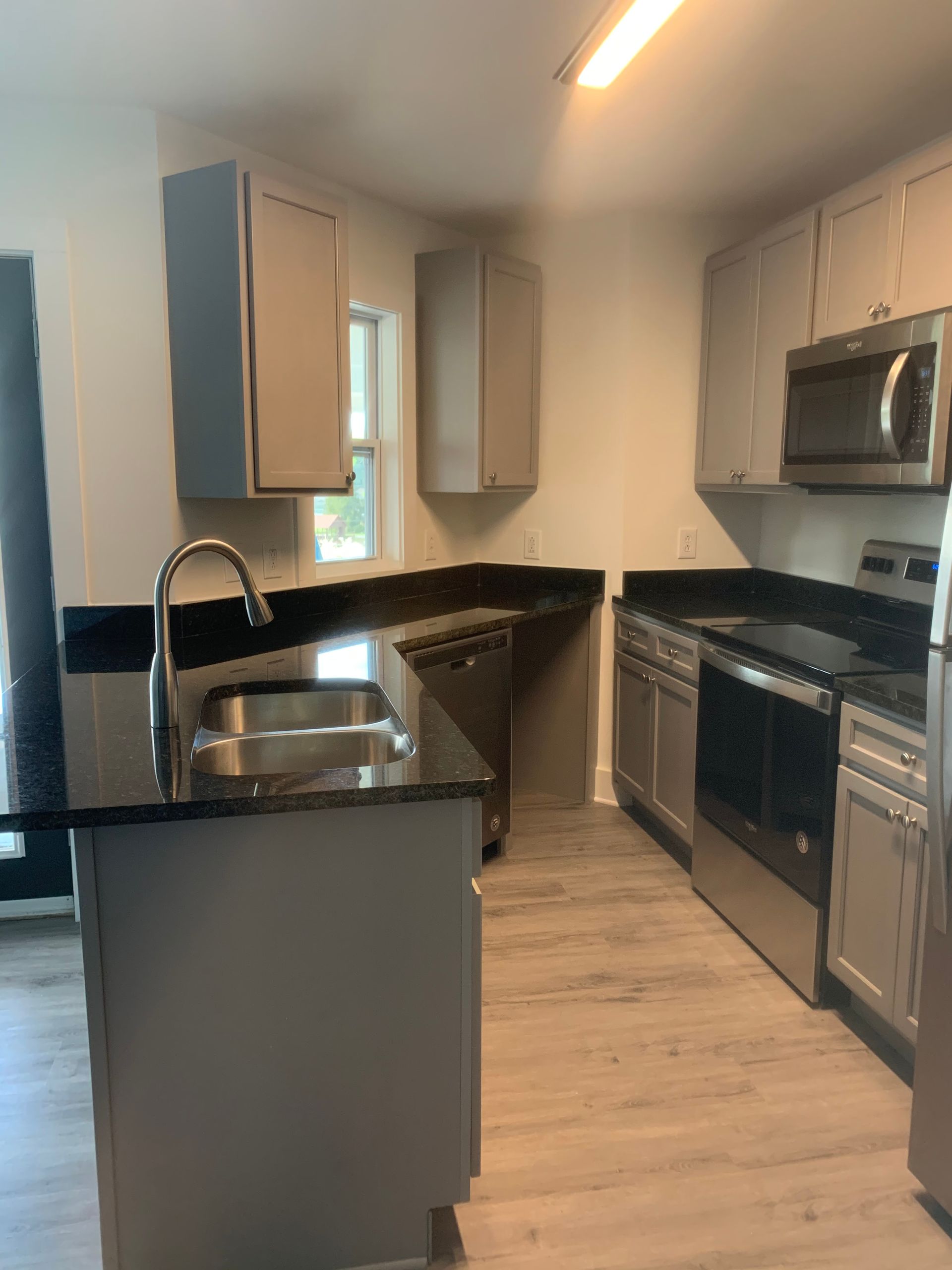 A kitchen with stainless steel appliances and granite counter tops