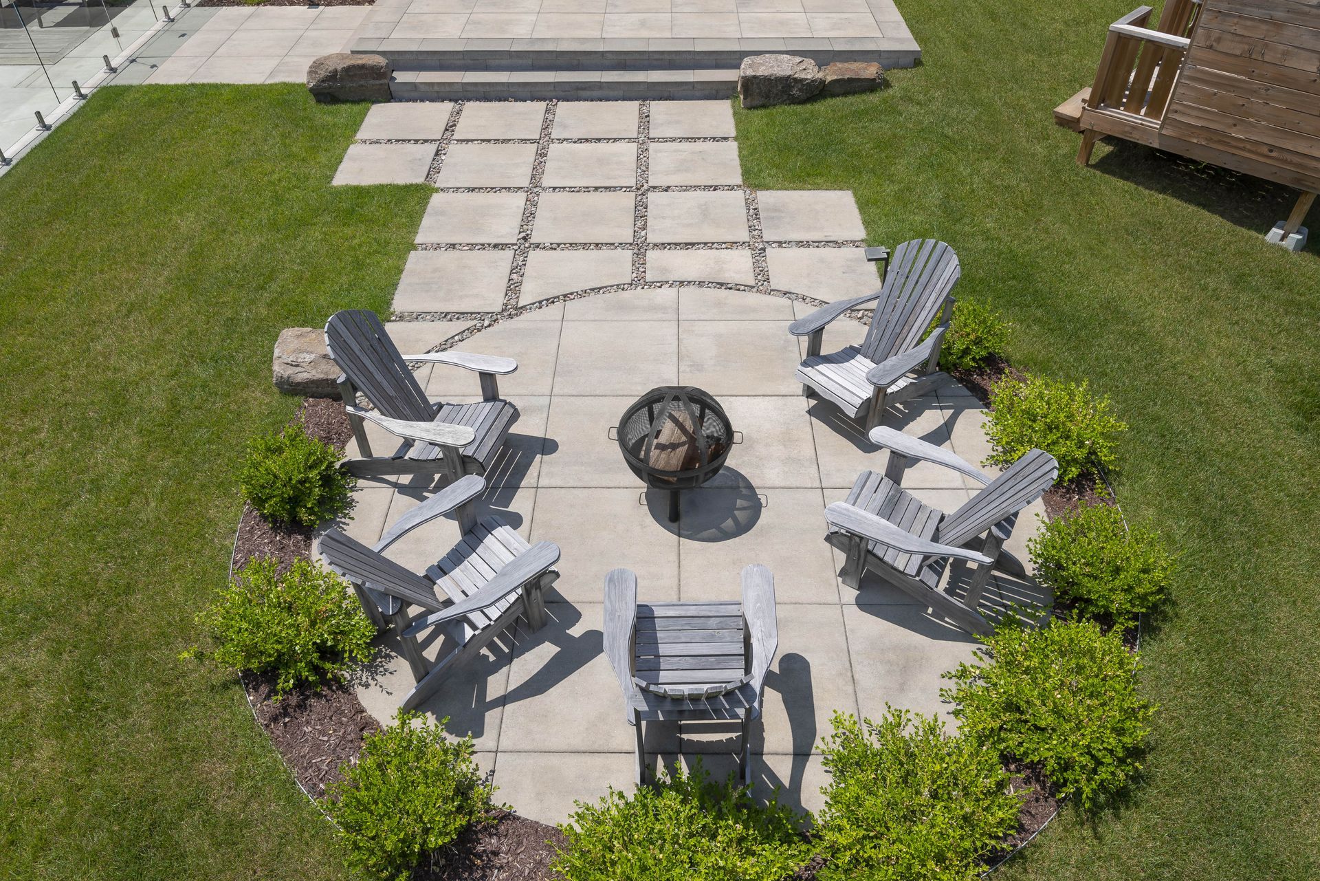 An aerial view of a patio with chairs and a fire pit.