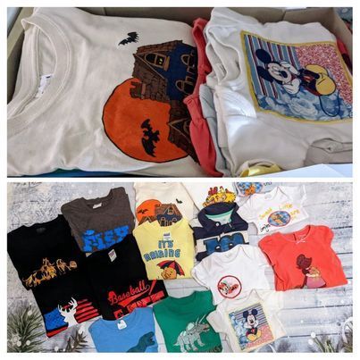 Assortment of t-shirts in a box and spread out, some with graphics like Mickey Mouse, Halloween, and baseball themes.