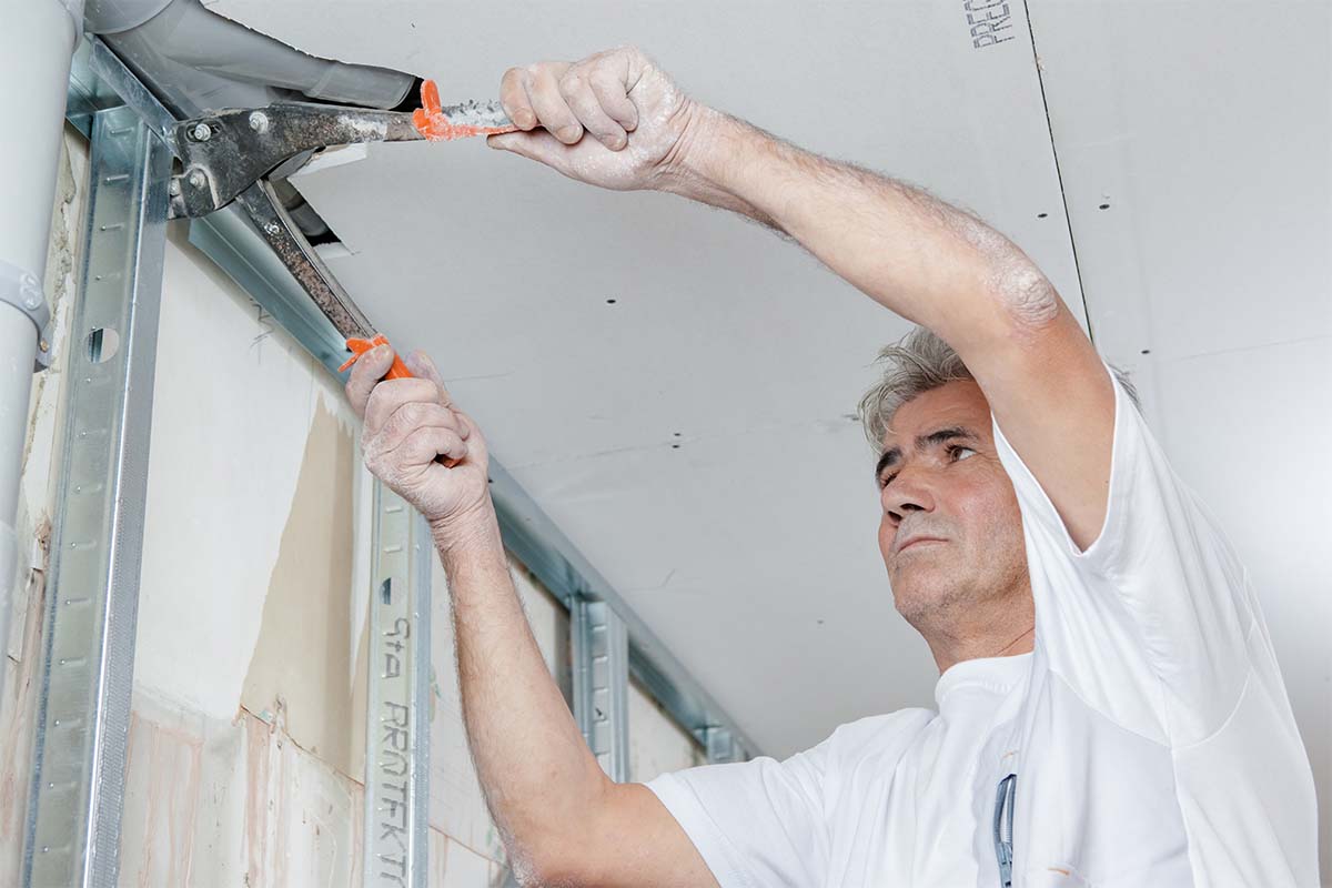 Plasterer Working On Ceilings And Walls