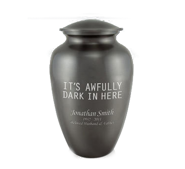 A black urn with the words `` it 's awfully dark in here '' engraved on it.