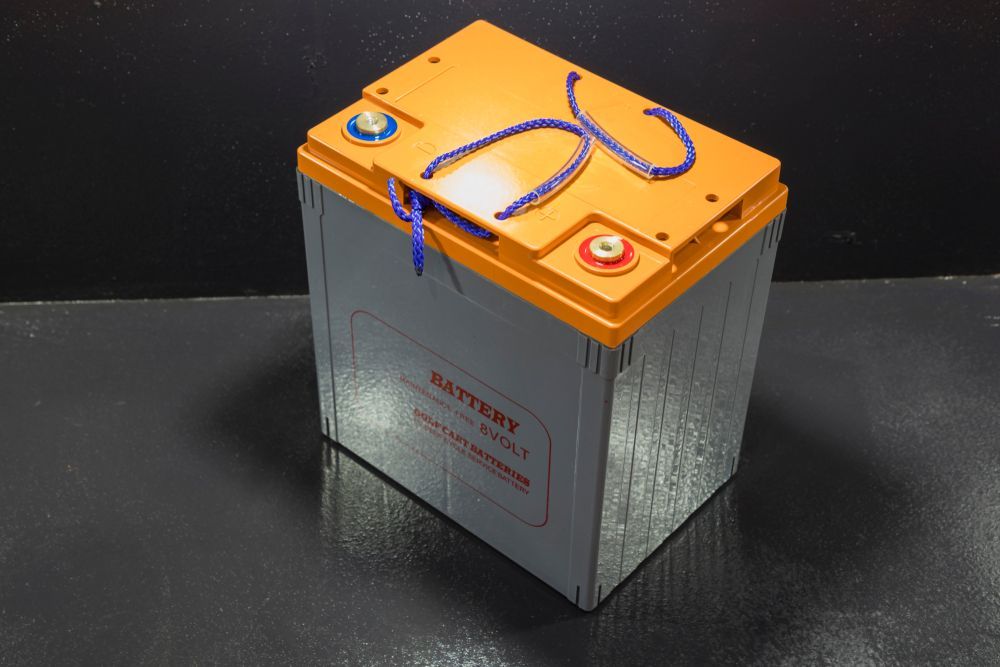 Orange-topped Metal Box With Blue Cord and Red Knob on a Dark Surface — Mareeba Tyre Centre in Mareeba, QLD