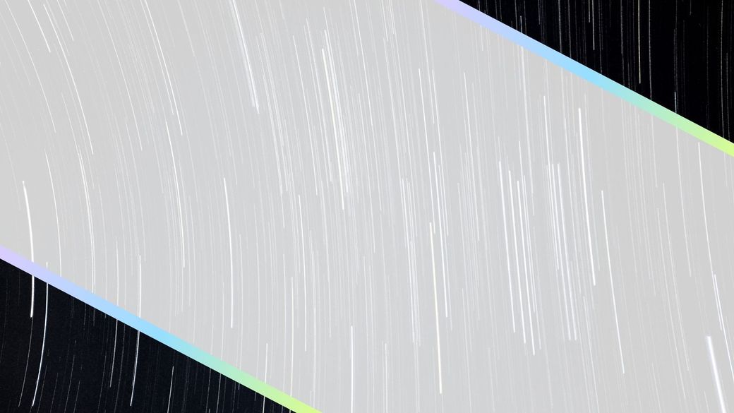 Gray diagonal panel with blue and green edges over a dark, rainy background