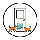 Two orange cats standing by a door with an open laptop on the floor