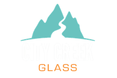 Teal mountain logo above the word “GLASS” in orange on a white background