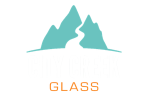 Teal mountain logo above the word “GLASS” in orange on a white background