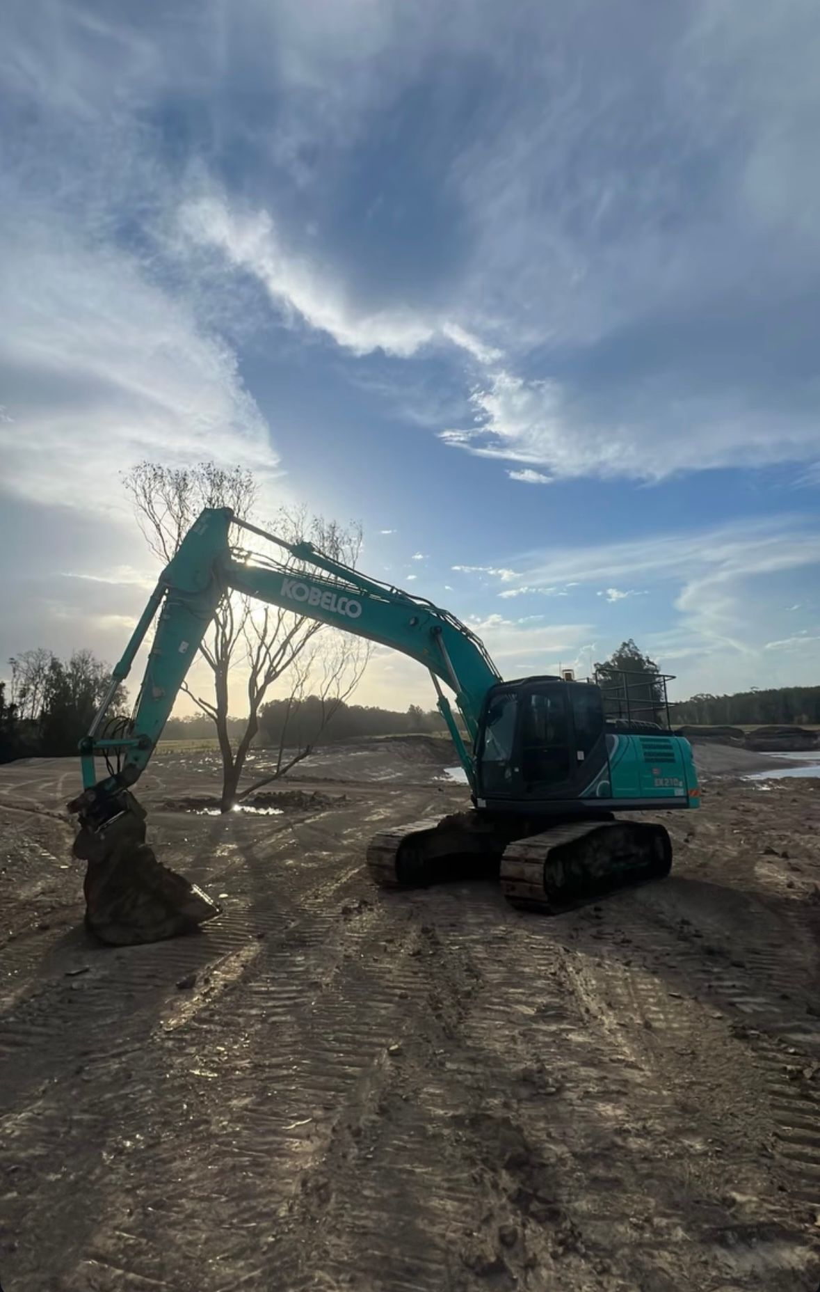 A Large Excavator is Sitting in the Middle of a Dirt Field — Jammach Earthmoving in Nulkaba, NSW