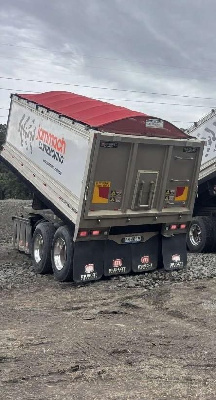 A Dump Truck Is Parked in A Dirt Field — Jammach Earthmoving in Nulkaba, NSW