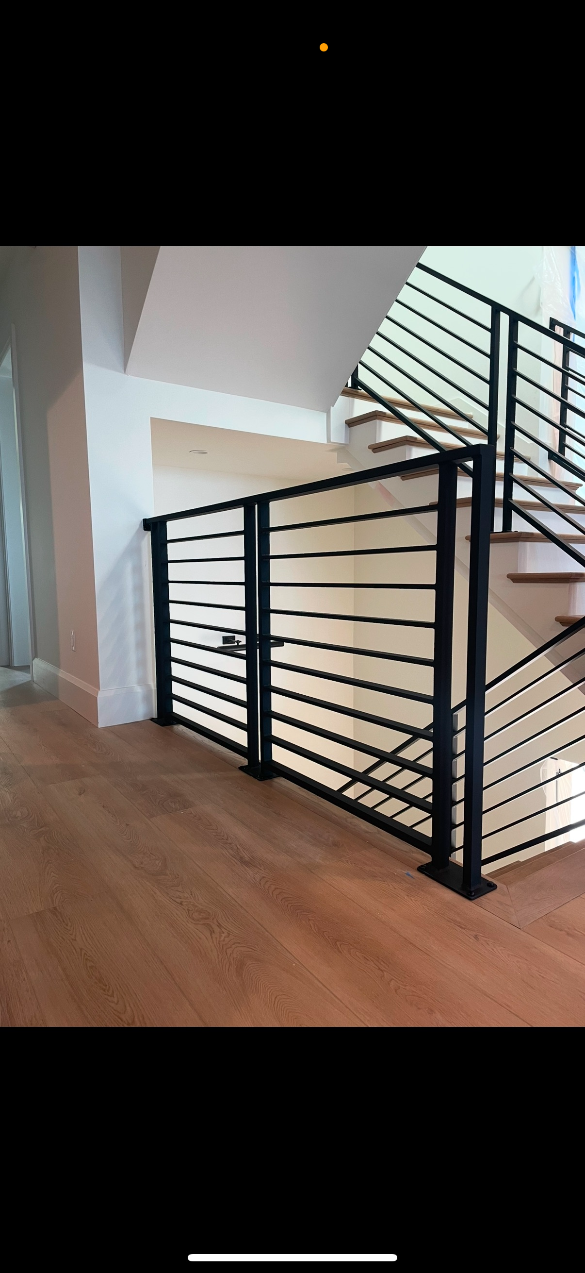 A picture of a staircase with a metal railing.