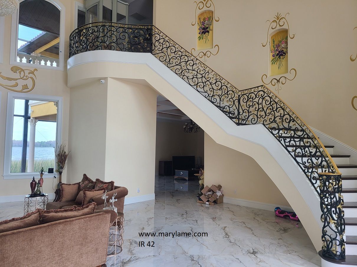 A living room with a staircase leading up to the second floor