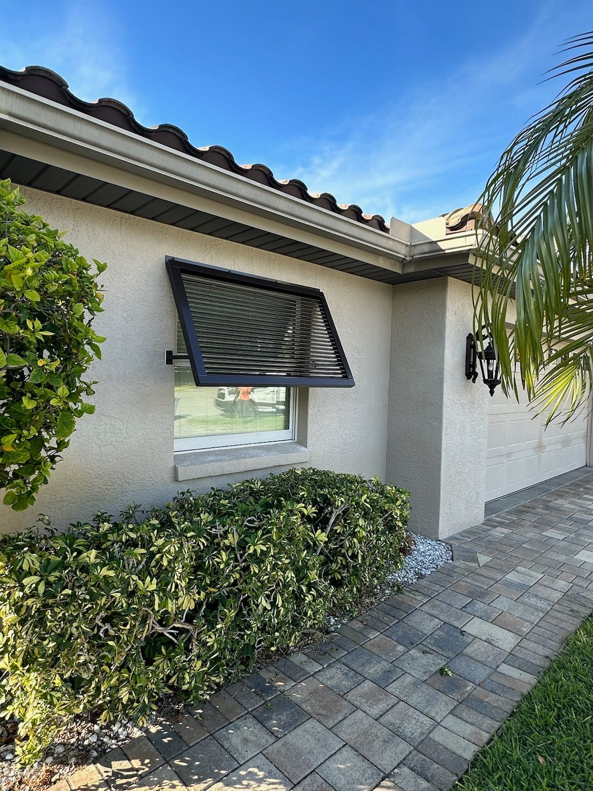 A house with a window with a awning on it.