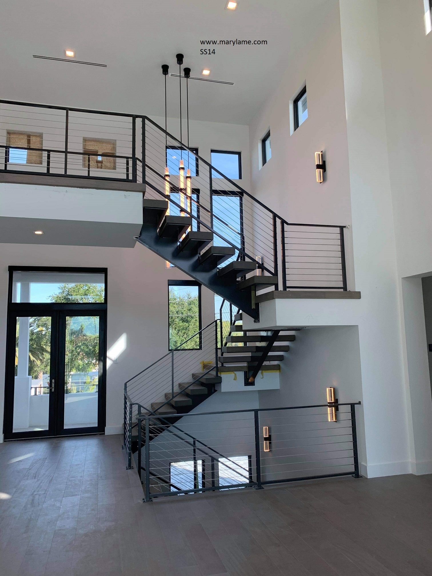 A large room with a staircase leading up to the second floor