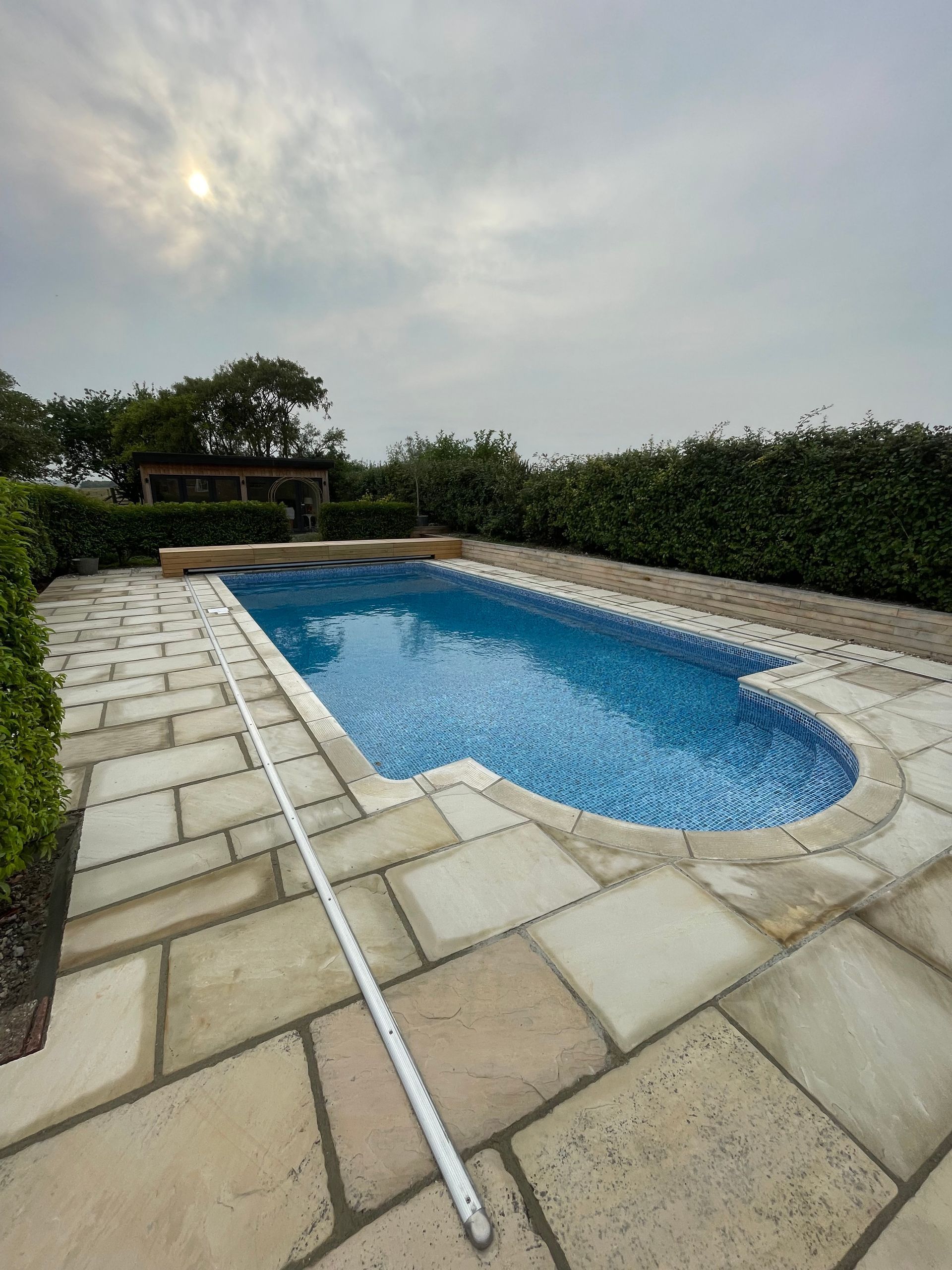 Beautiful Outdoor pool with new sandstone paving and Oak pool cover