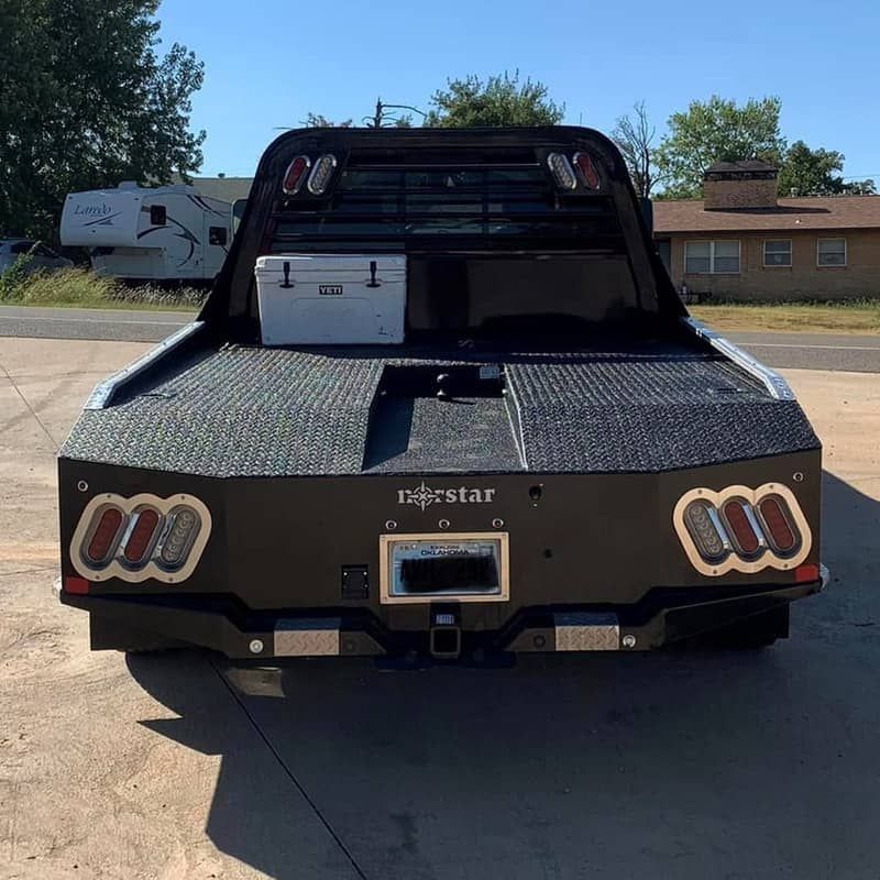 rearview of black steel western hauler bed with chrome accents around taillights