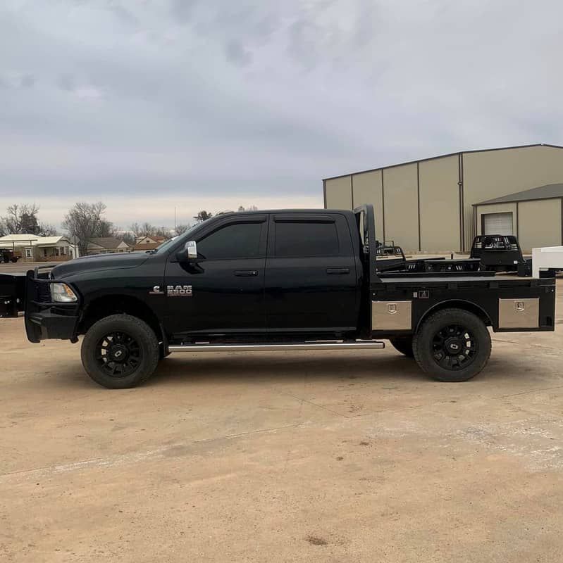 black dodge 4 door truck with black skirted bed 
