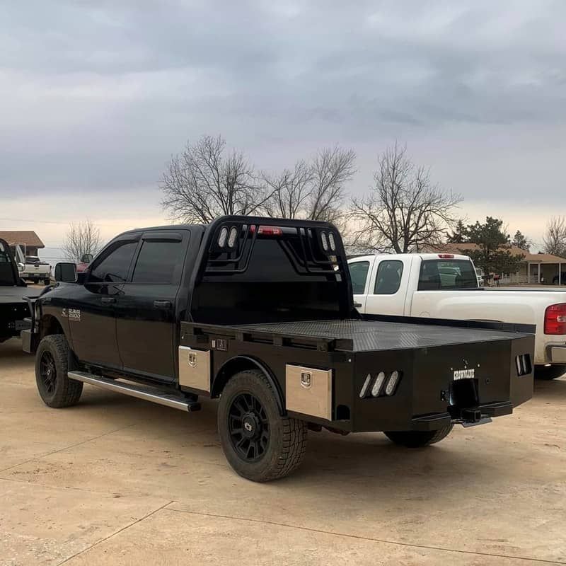 black dodge 4 door truck with black skirted bed rear view