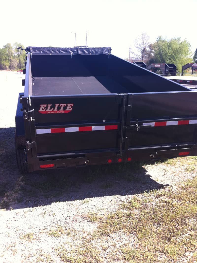 rear view of black Elite dump trailer with tarp in front