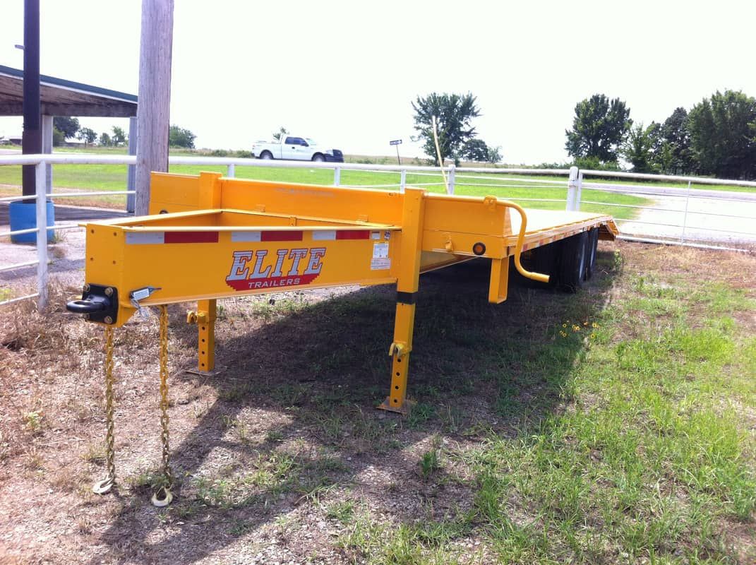 yellow flat deck trailer with pintle hitch