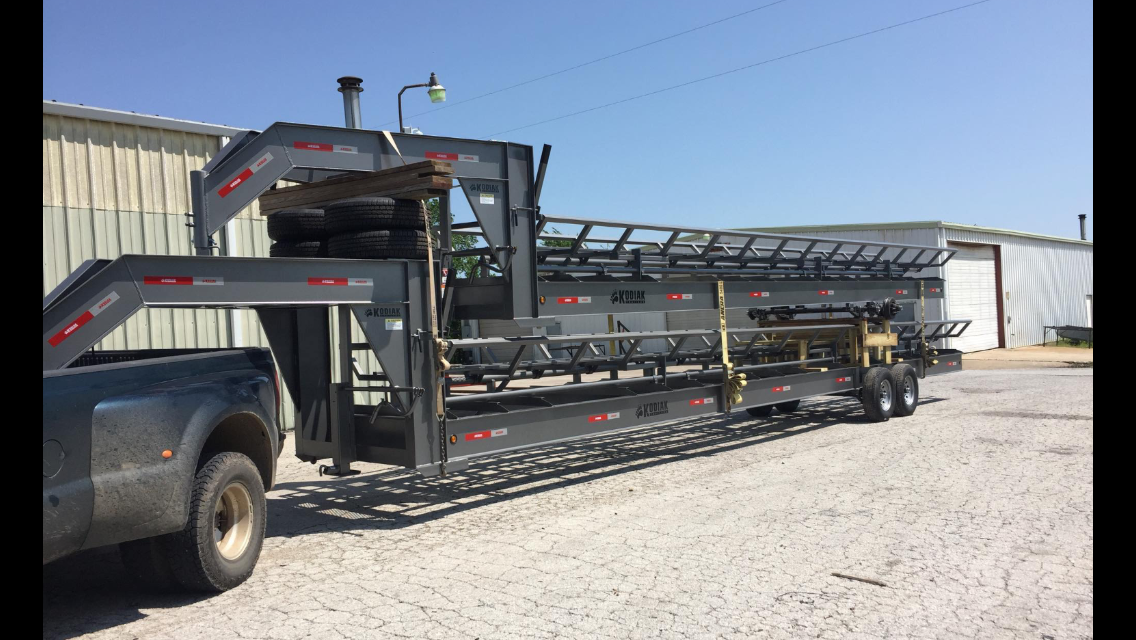 two gray hay trailers stacked on top of each other