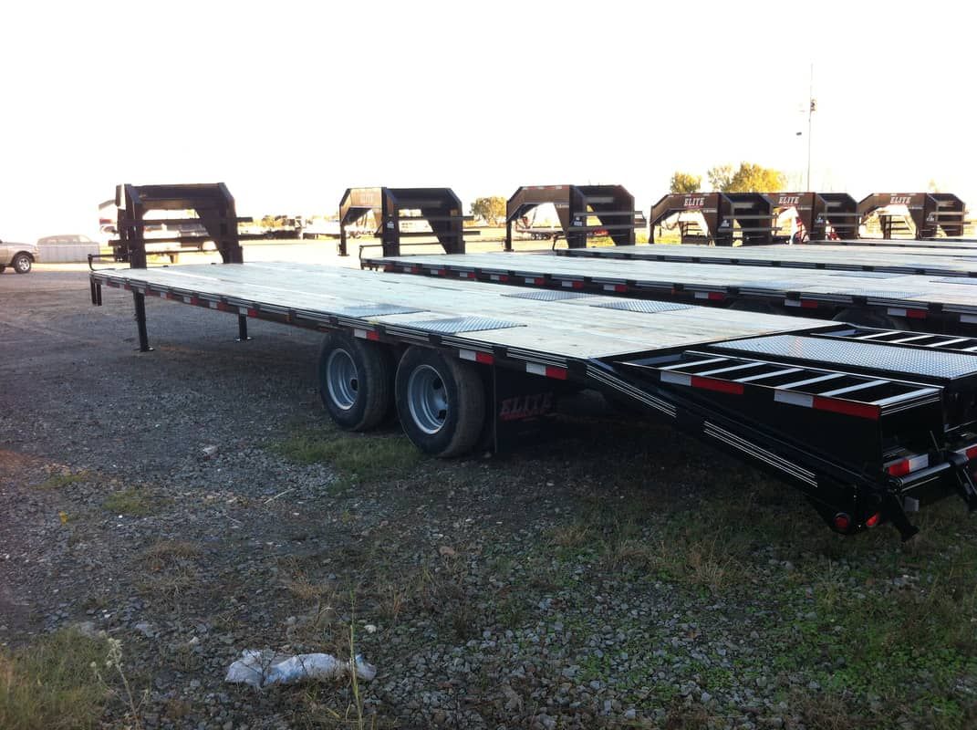 row of black gooseneck trailers