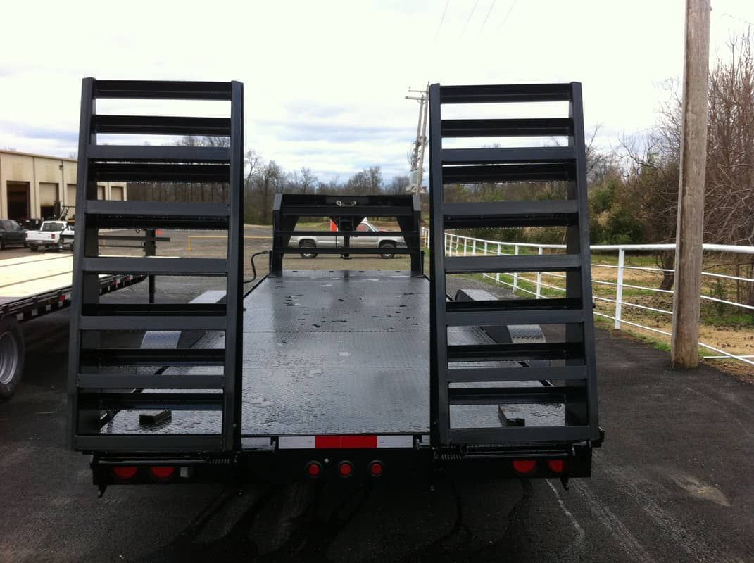 black steel floor trailer with 2 ramps in upright position